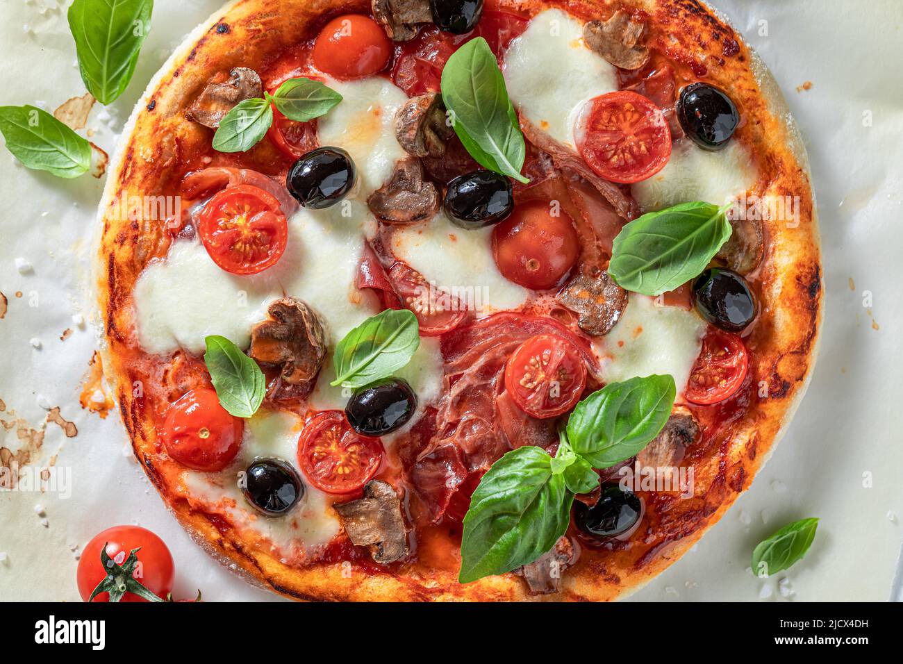 Fresh and crunchy pizza Capricciosa with mozzarella, tomatoes and