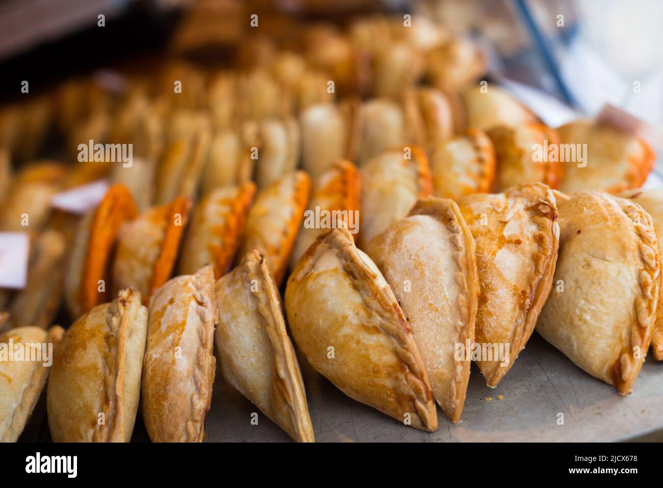 freshly baked empanadas with different fillings for sale Stock Photo