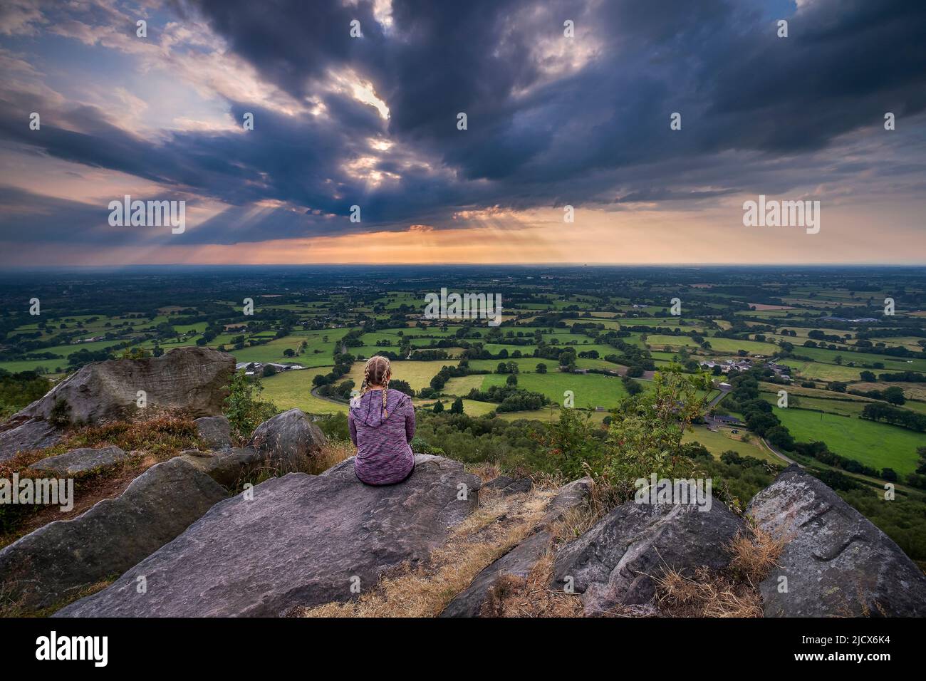 A girl looks out over the Cheshire Plain from Bosley Cloud, Cheshire, England, United Kingdom, Europe Stock Photo
