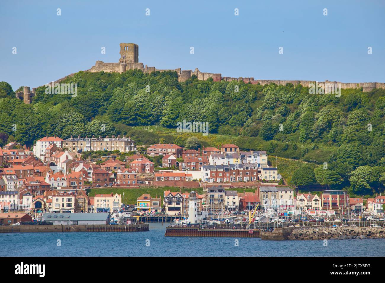 View of South Bay looking towards harbour and Scarborough Castle, Scarborough, Yorkshire, England, United Kingdom, Europe Stock Photo