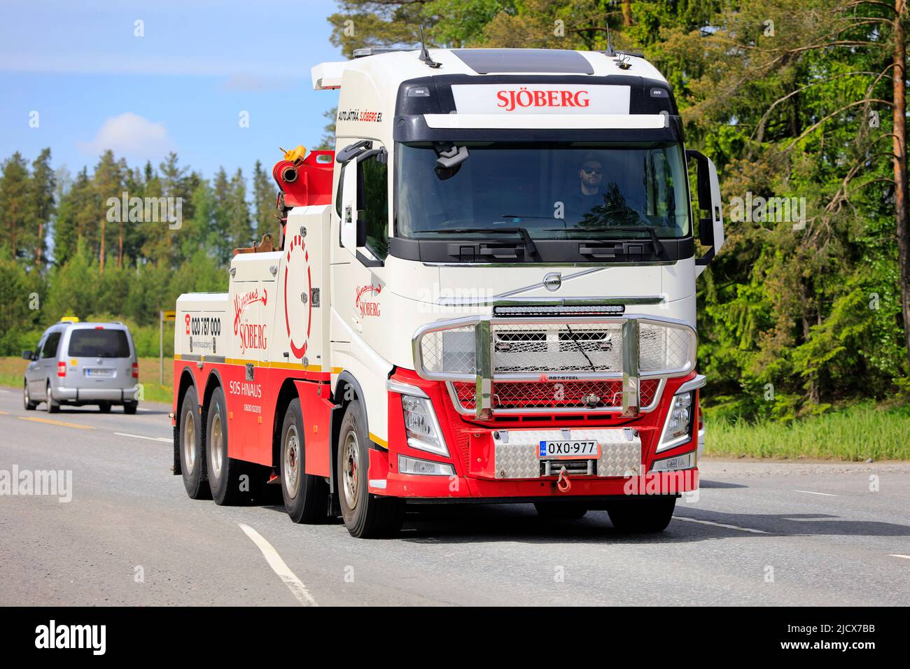 Volvo FH heavy duty recovery vehicle Hinaus Sjöberg Oy for towing semi trucks on Highway 2 traffic in the summer. Jokioinen, Finland. June 10, 2022. Stock Photo