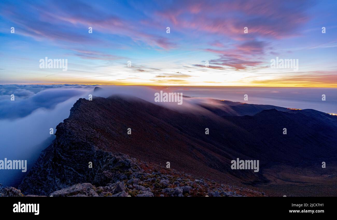 Dramatic sky at dawn over Pico de la Zarza mountain peak in mist ...