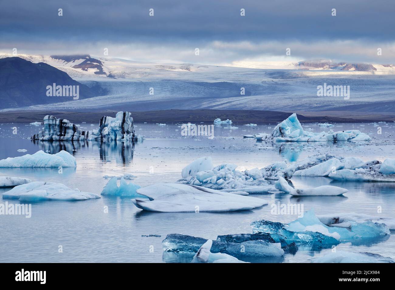 Ice floes in the lagoon at Jokulsarlon, looking towards the Vatnajokull icecap, Vatnajokull National Park, south coast Iceland, Polar Regions Stock Photo