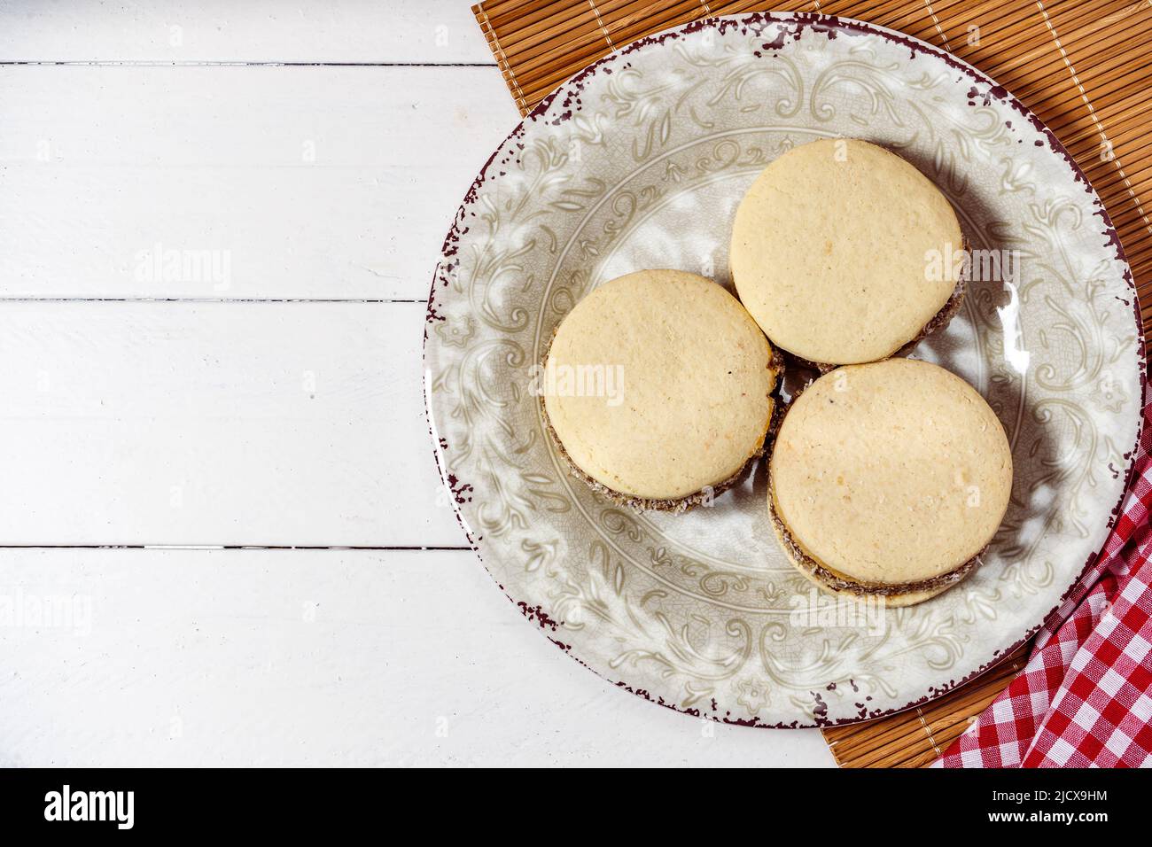 Classic Argentinean cornstarch and dulce de leche alfajores with coconut on  a vintage plate. Top view. Copy text. sweet snack Stock Photo - Alamy, image size:1300x956