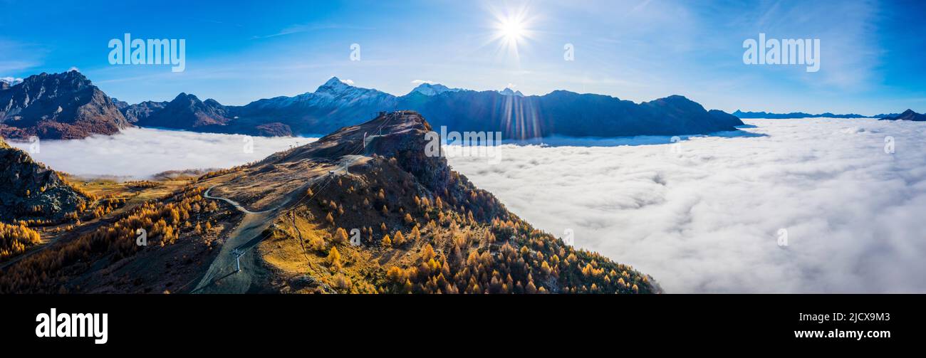 Valmalenco ski slopes with autumn colors and clouds covered Valmalenco valley, Valtellina, Lombardy, Italy, Europe Stock Photo