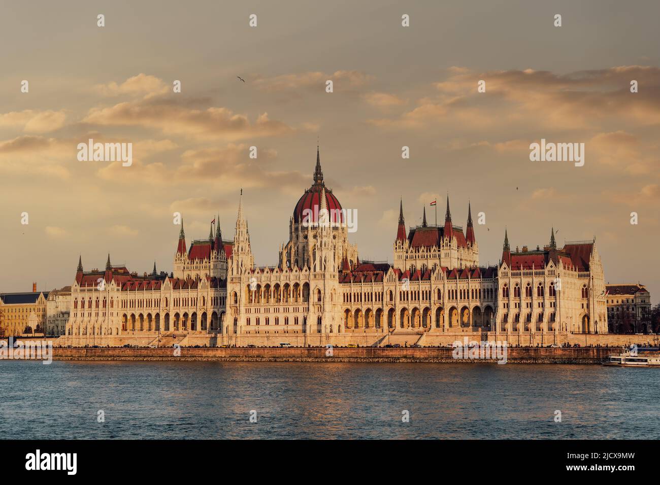 Orszaghaz Parliament neo-Gothic building and River Danube view at sunset, with clouds above, UNESCO World Heritage Site, Budapest, Hungary, Europe Stock Photo