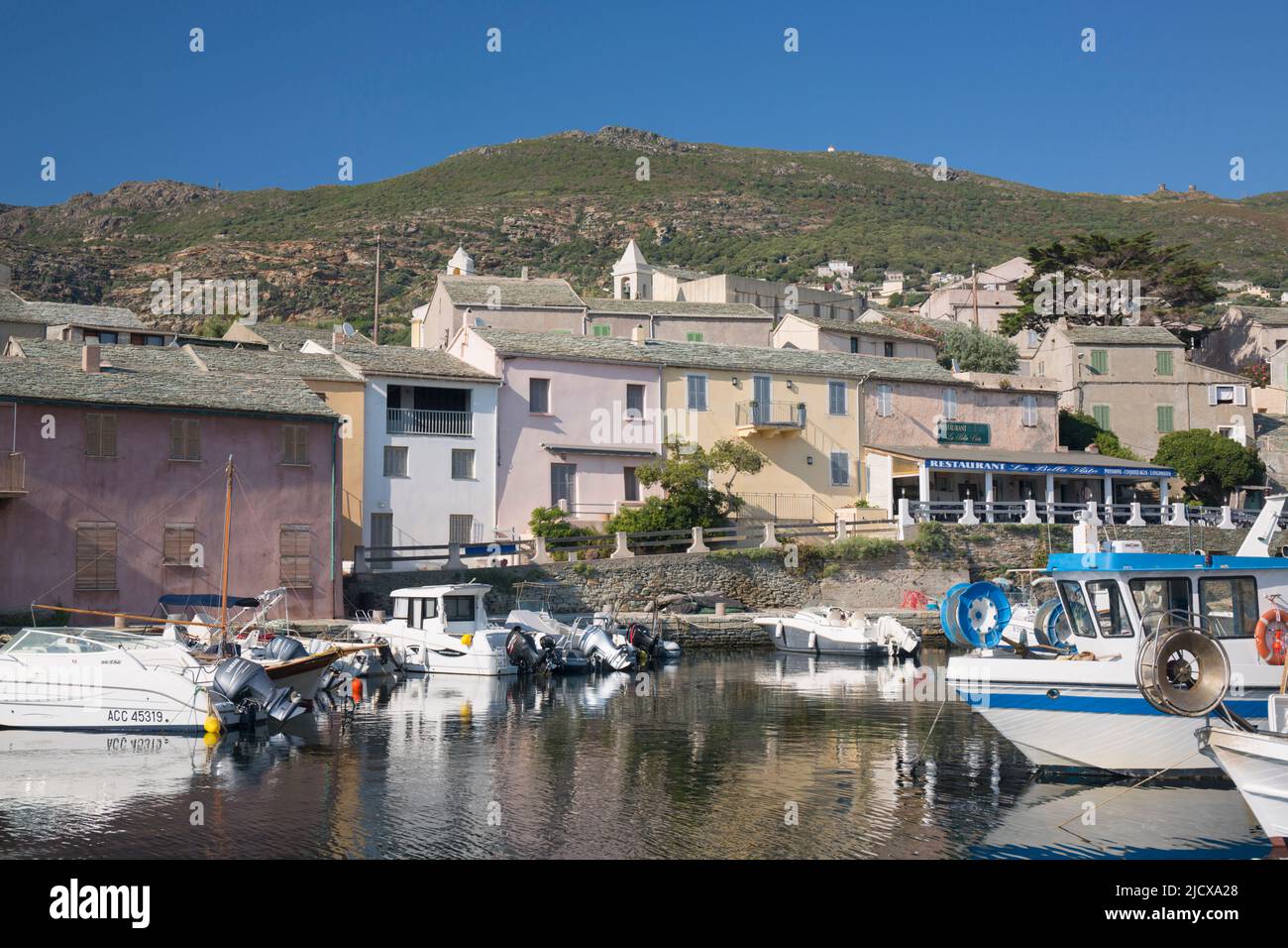 View across the tranquil harbour to typical slate-roofed houses, Centuri-Port (Port de Centuri), Haute-Corse, Corsica, France, Mediterranean, Europe Stock Photo