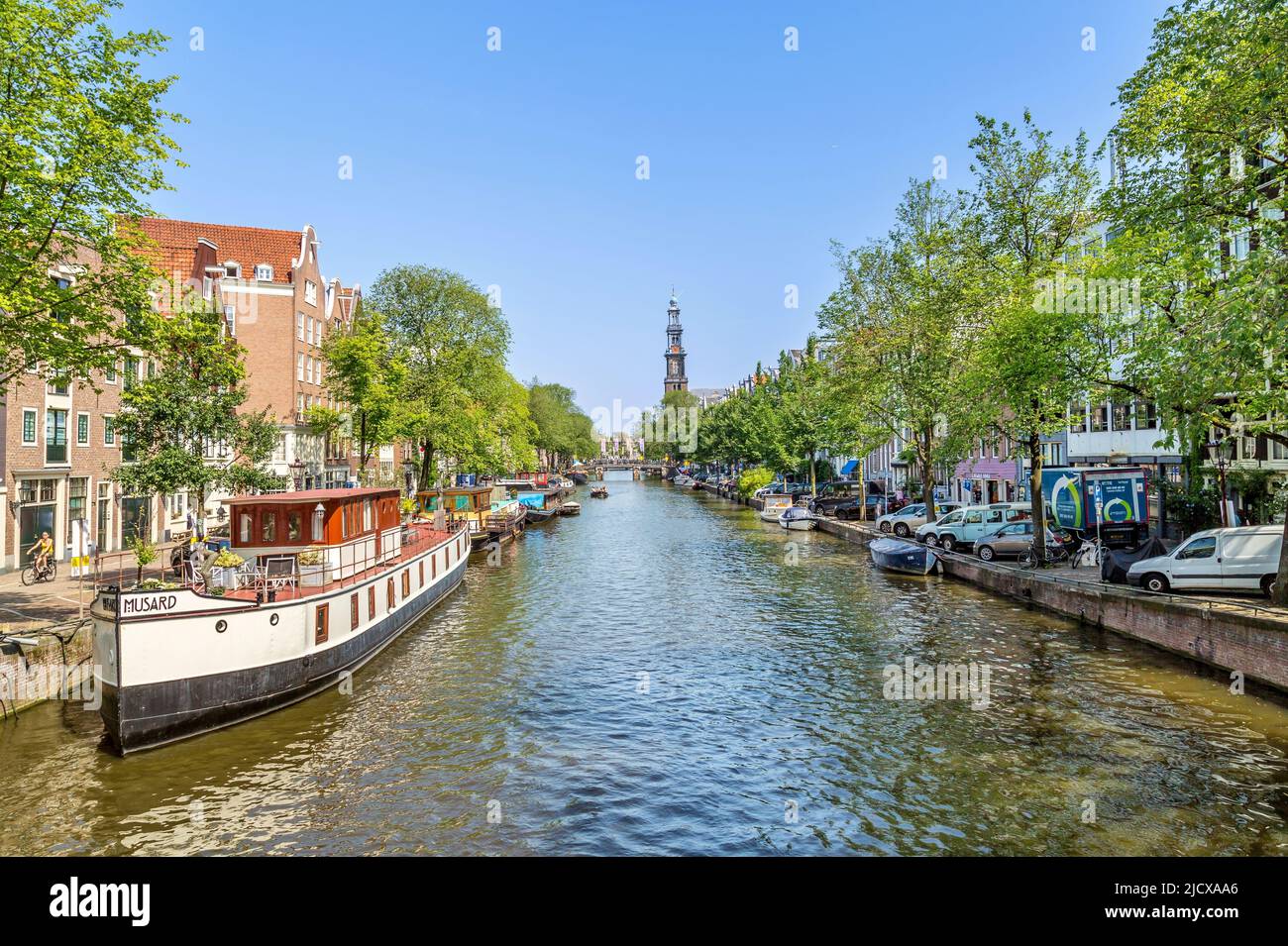 Boats on the Prinsengracht canal, with the Westerkerk church behind, Amsterdam, North Holland, The Netherlands, Europe Stock Photo