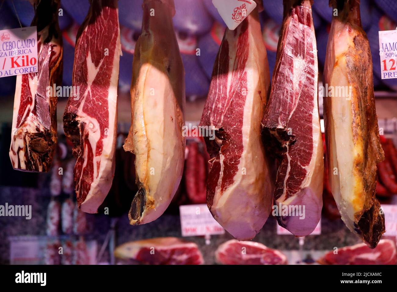 Cured ham (Jamon Iberico) hanging at market, Madrid, Spain, Europe Stock Photo