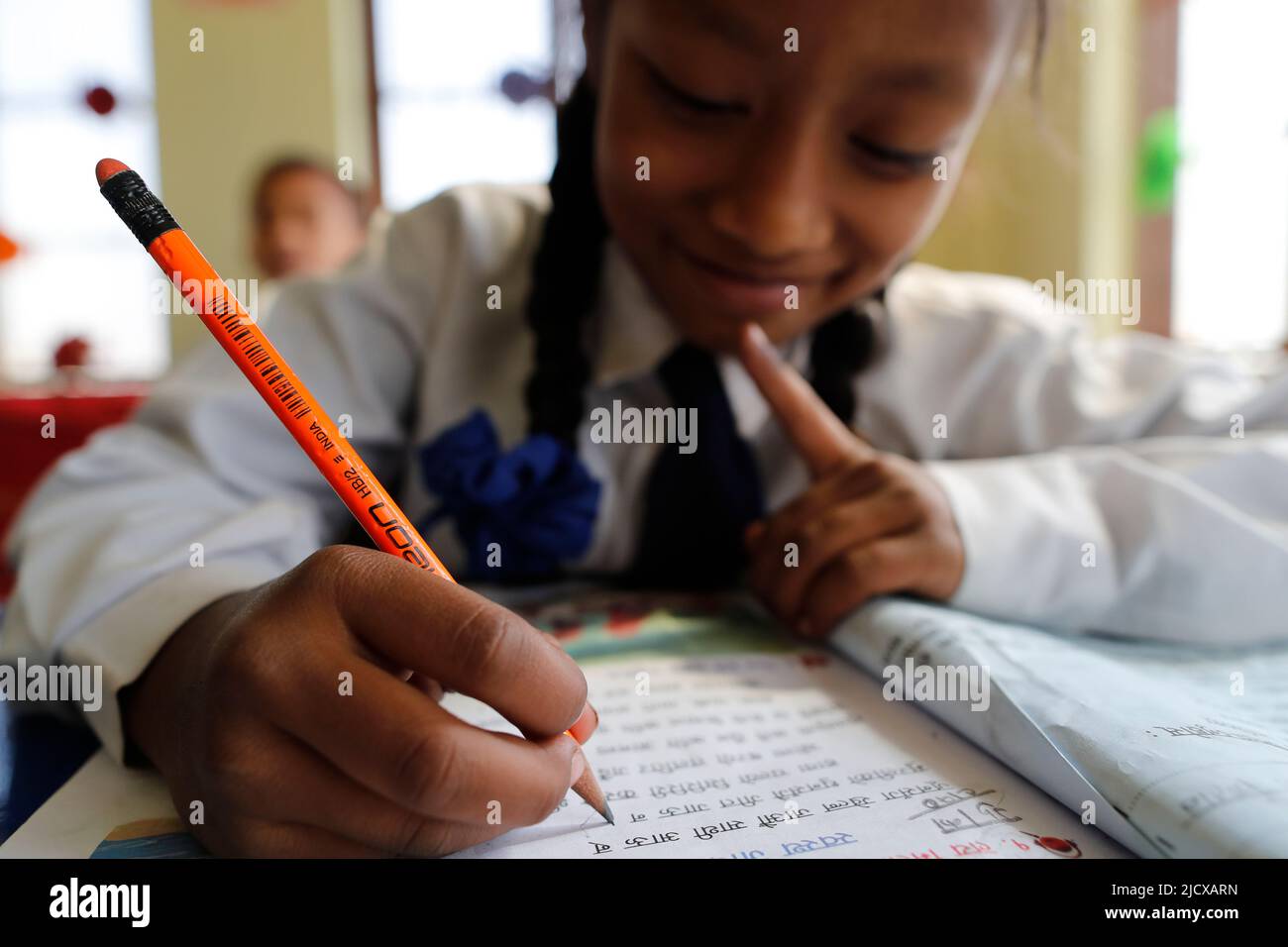 Primary school, girl in classroom with pencil, concept of education and school life, Kathmandu, Nepal, Asia Stock Photo