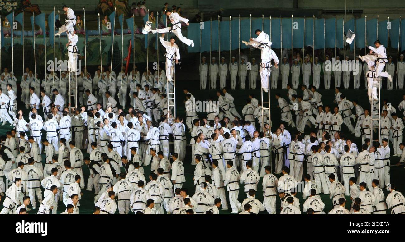 North Korean workers and students perform North Korea's biggest propaganda spectacle called the Arirang, at the May Day stadium on October 3, 2007 in Pyongyang, North Korea. Roh and Kim are holding a three day summit aimed eliminating over 50-years of animosity between the two counties, who have been technically at war since 1950. Stock Photo