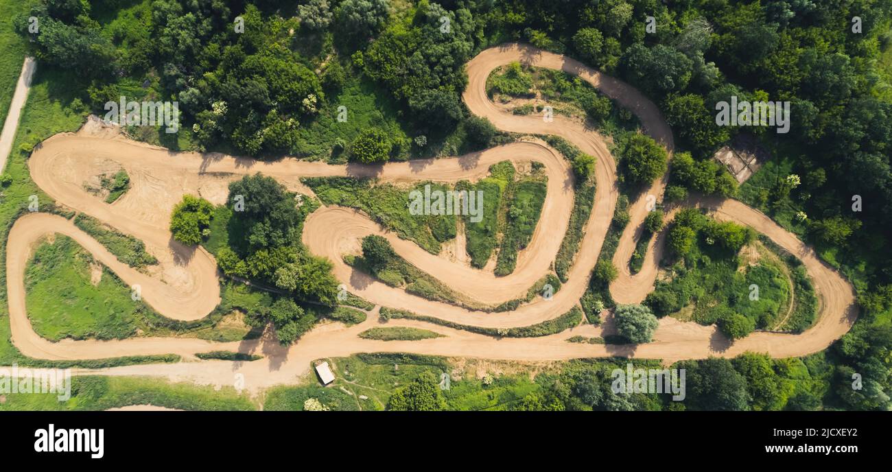 Motocross track in the middle of a green countryside. Horizontal drone shot. High quality photo Stock Photo