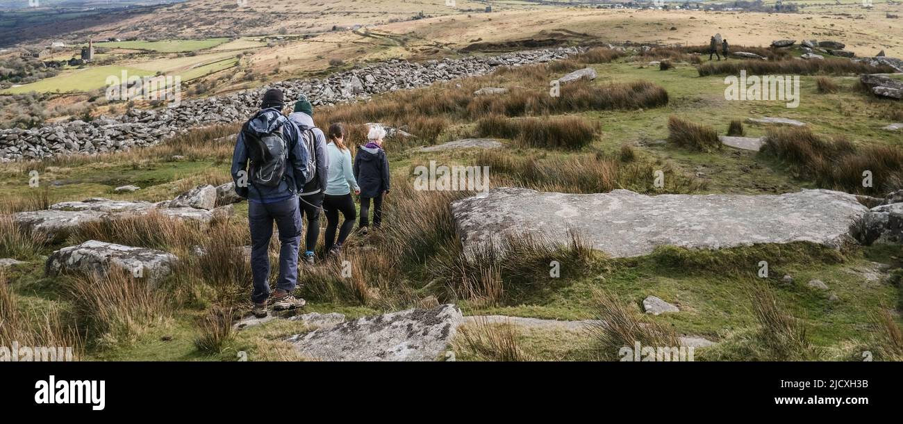 A panoramic image of people walking down Stowes Hill on Bodmin Moor in Cornwall. Stock Photo
