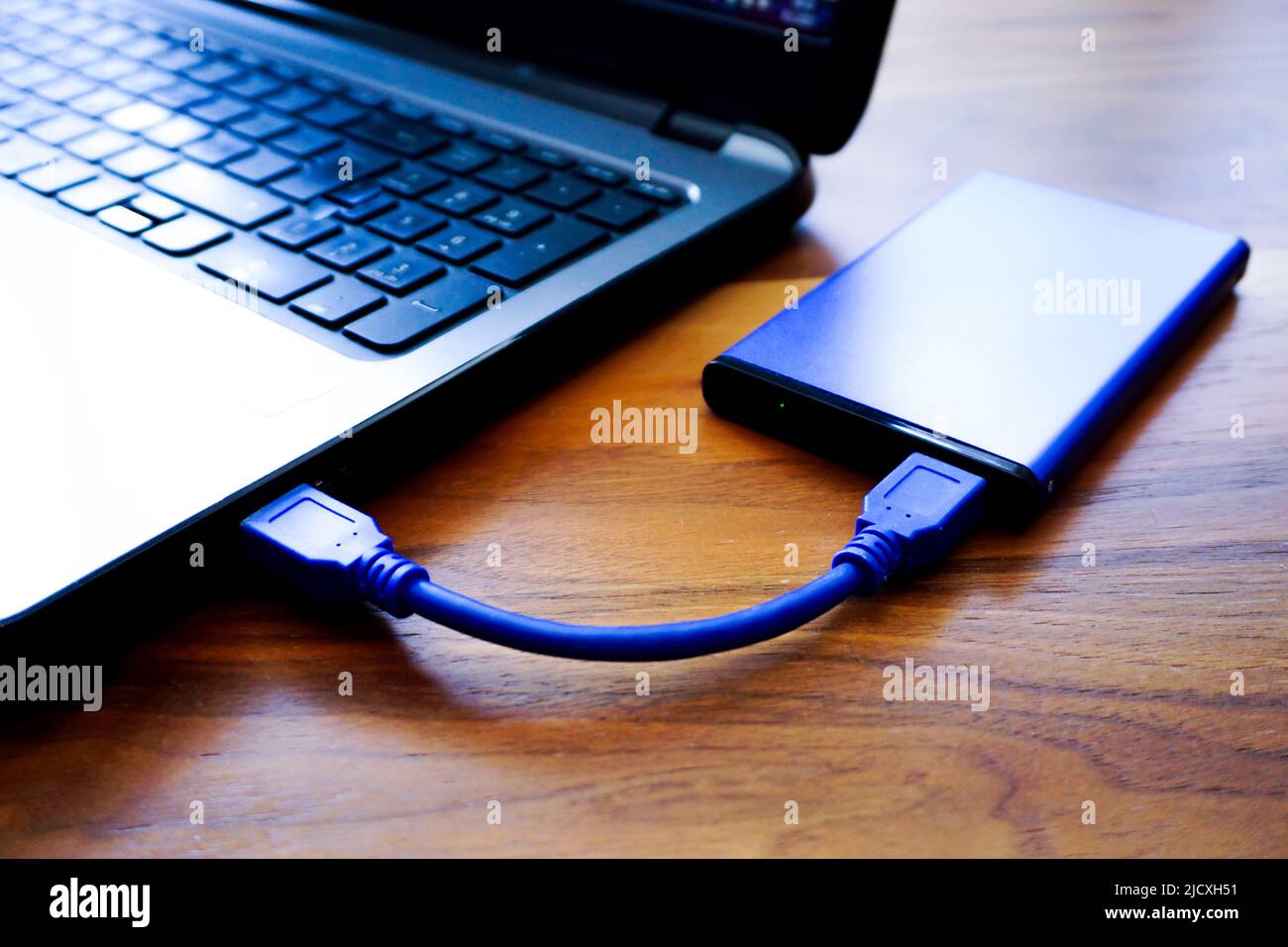 External hdd connected to laptop close up view Stock Photo