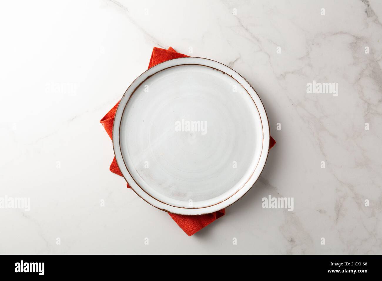 Overhead view of empty plate lenne napkin on marble surface food concept Stock Photo