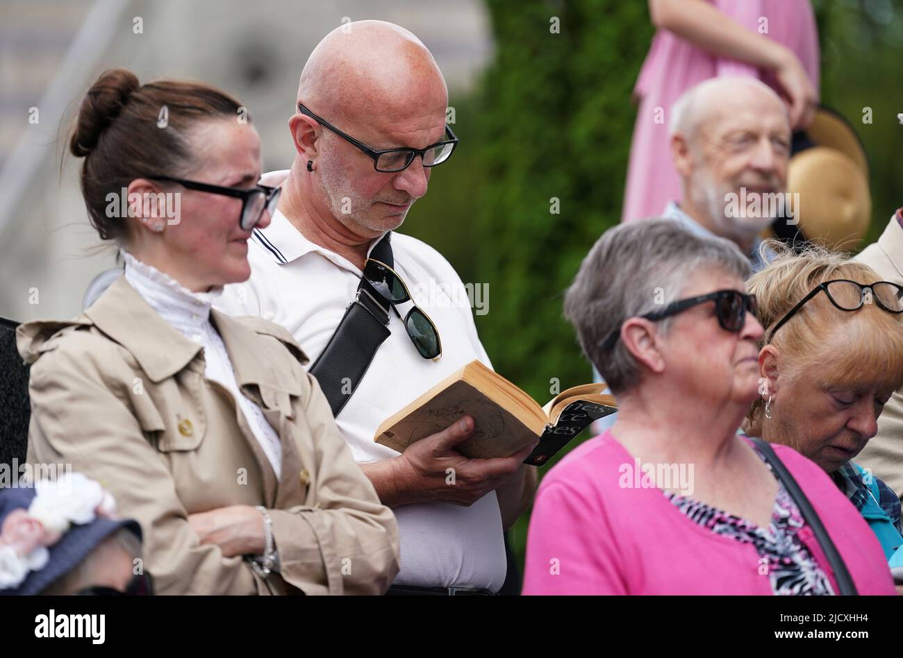 People attend a Joycestagers reenactment from the 'Hades' chapter of Ulysses at Glasnevin Cemetery, Dublin, as part of the annual Bloomsday celebrations. Bloomsday is a celebration of the life of Irish writer James Joyce, observed annually worldwide on June 16, the day his 1922 novel Ulysses takes place in 1904, the date of his first outing with his wife-to-be Nora Barnacle. The day is named after its protagonist Leopold Bloom. Picture date: Wednesday August 25, 2021. Stock Photo