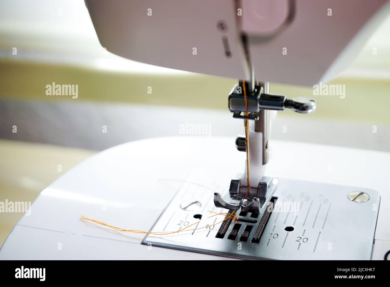 Sewing machine needle bobbin and stitch settings details close up view
