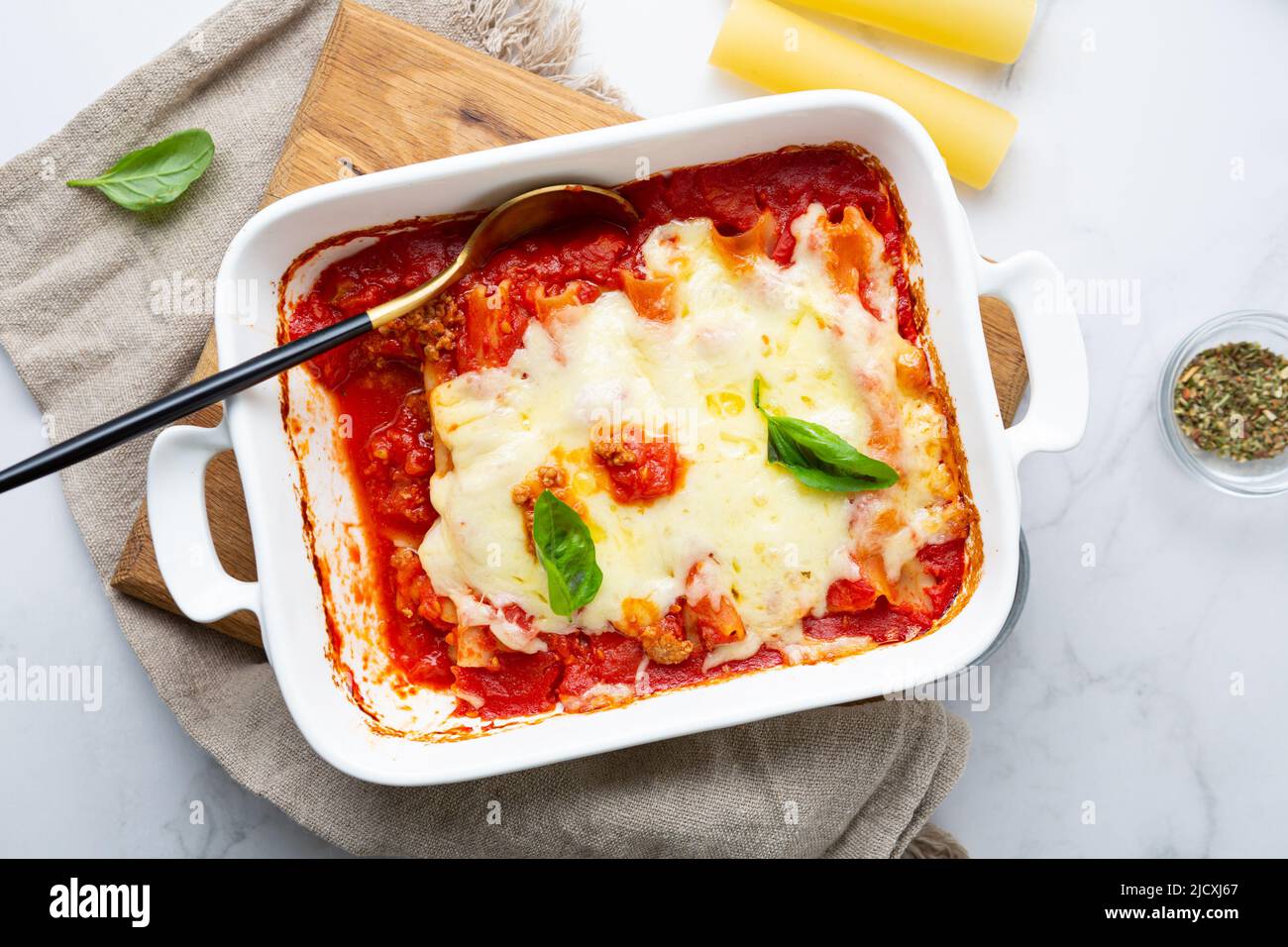 Overhead view of italian baked pasta canelloni food in baking dish Stock Photo