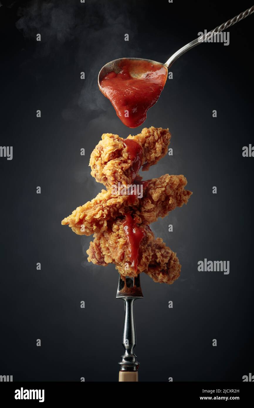 Delicious crispy fried chicken with tomato sauce. Fried chicken with