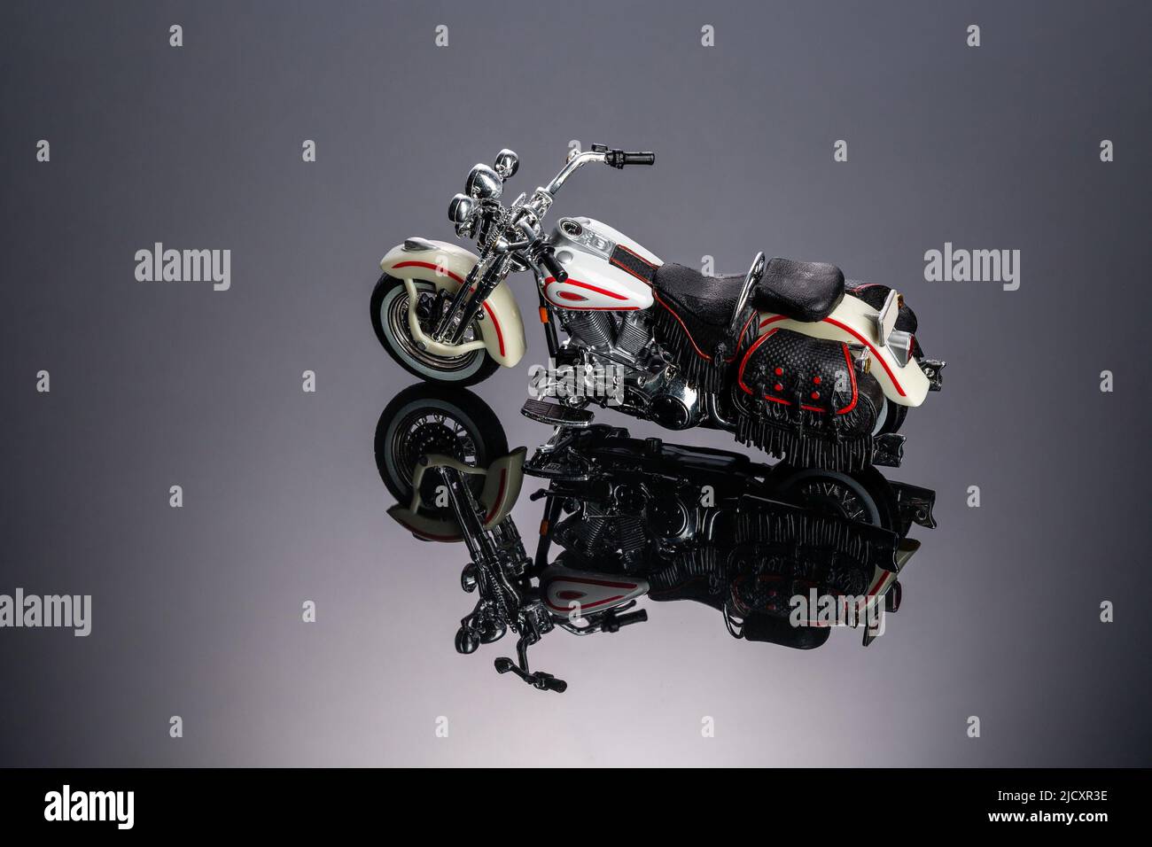 Toy motorcycle on a piece of black acrylic  Stock Photo