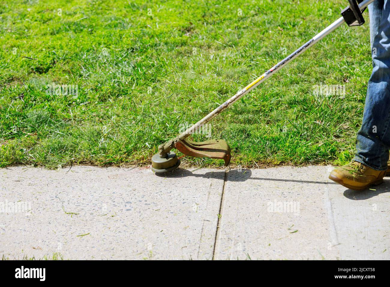 Landscaper men gardener cutting grass with string lawn trimmers Stock Photo Alamy