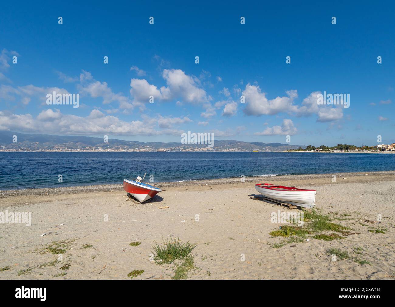 Two small wooden boats on sandy beach in southern Italy Stock Photo