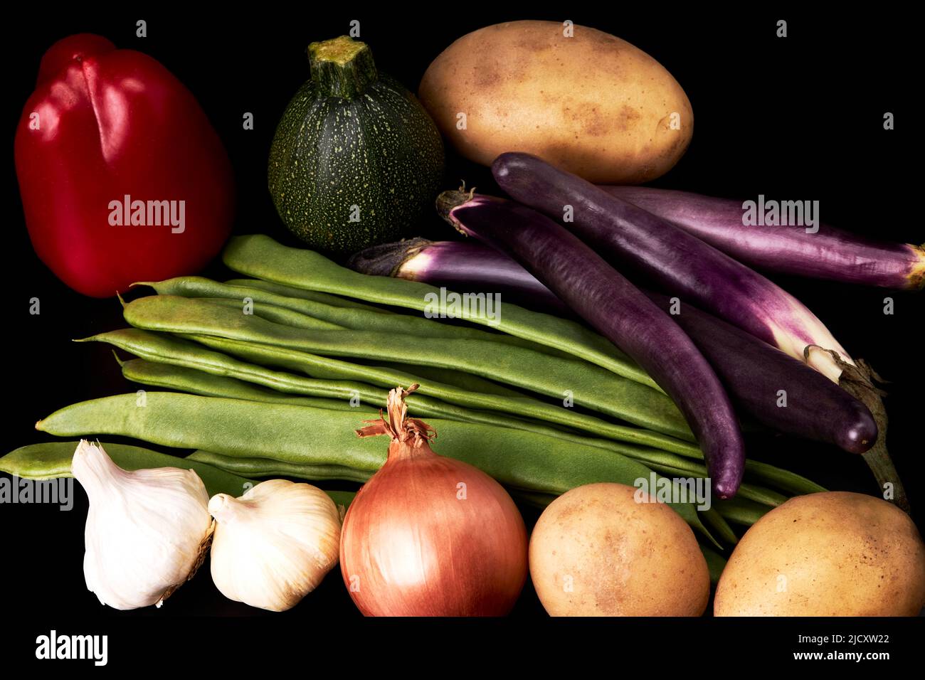 Variety of juicy vegetables on a black background. Healthy food. Vegetarian food Stock Photo