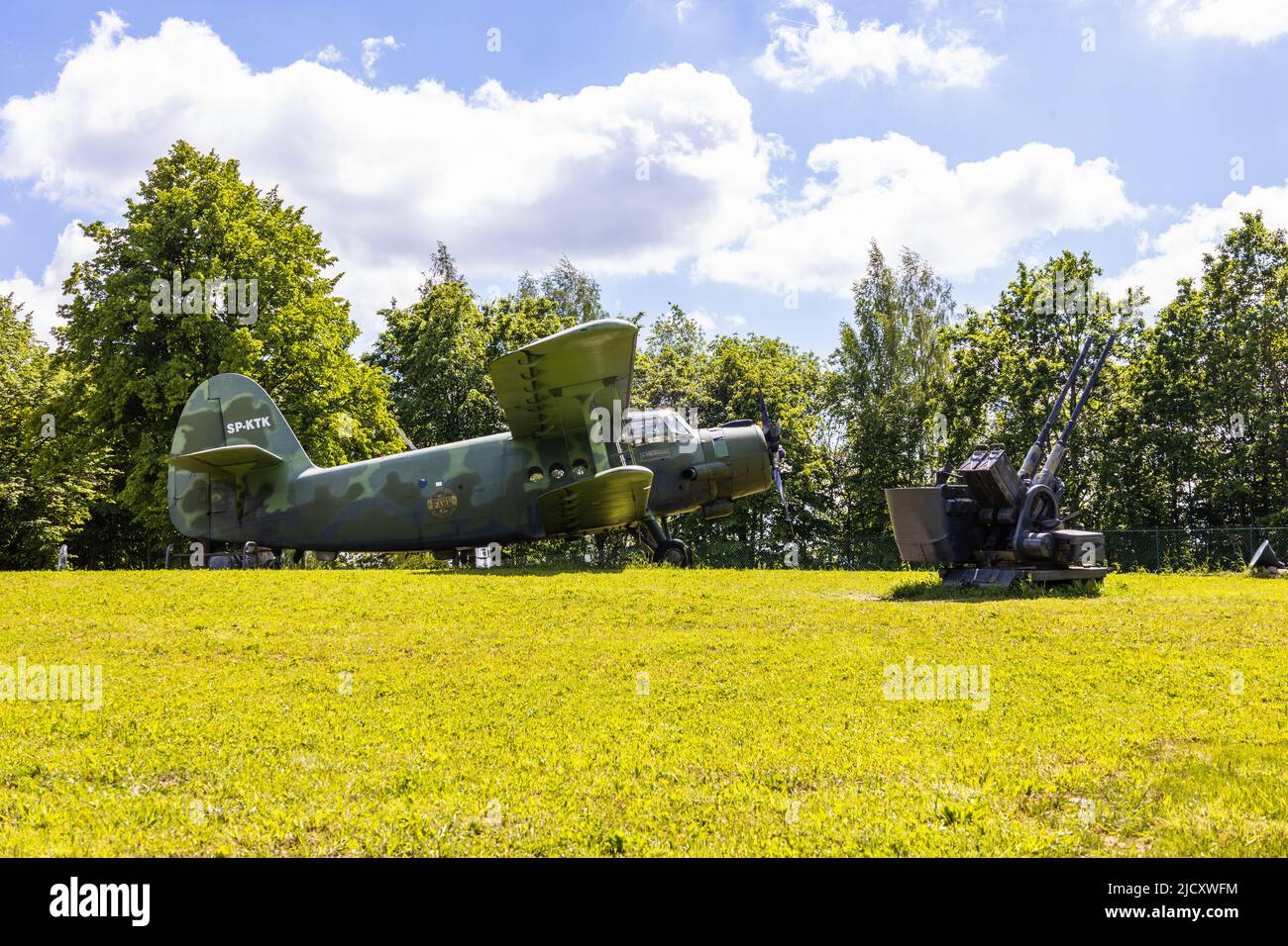 Transport aircraft and anti-aircraft guns in the outdoor museum. Ketrzyn, Poland, 11 June 2022 Stock Photo