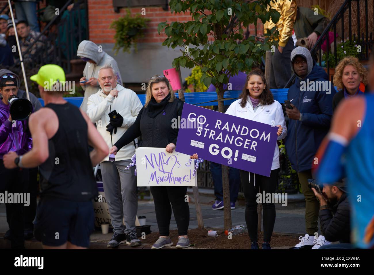 Brooklyn, New York, USA - November 3. 2019: Fans cheering on Marathon runners on sidewalk during running race Stock Photo