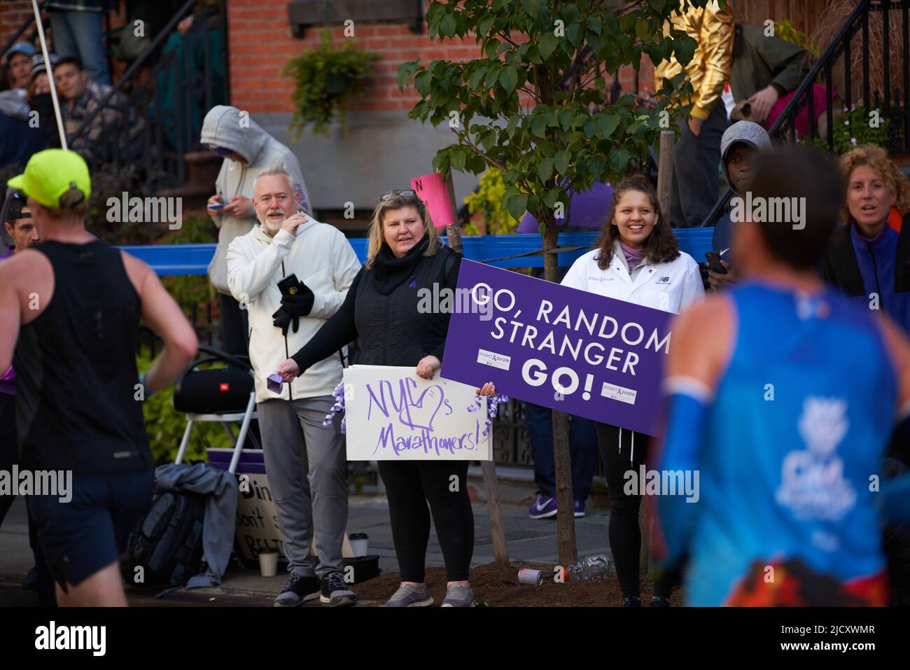 Brooklyn, New York,USA - November 3. 2019: Fans cheering on Marathon runners on sidewalk during running race Stock Photo
