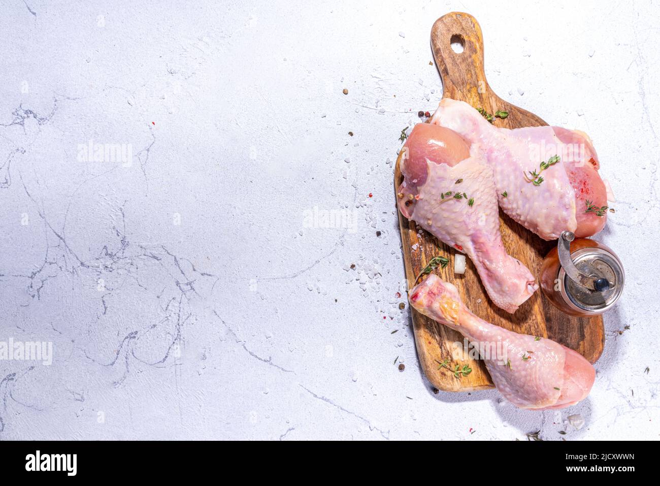 Raw chicken drumsticks with spices for cooking. Raw chicken drumsticks