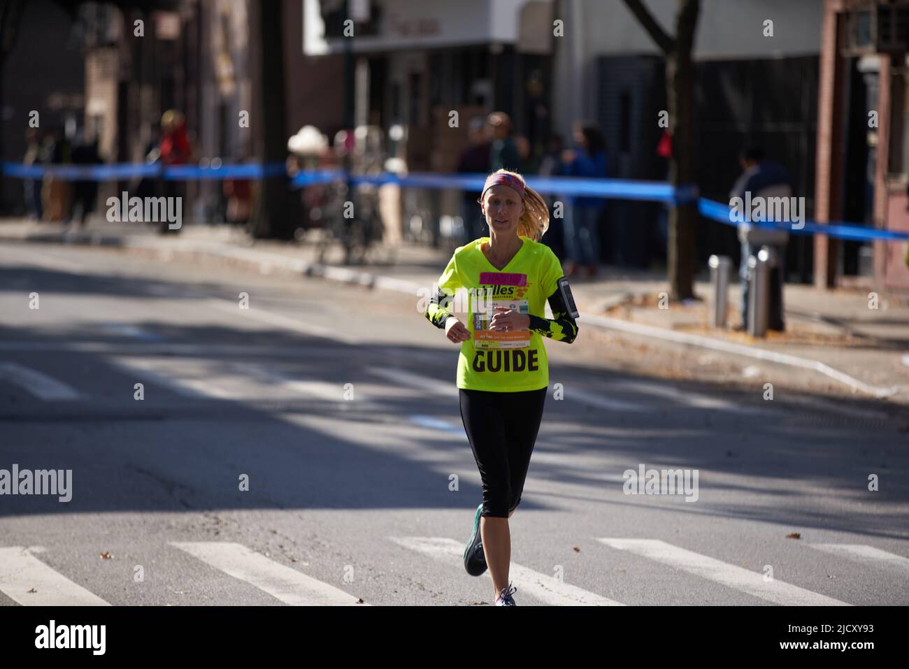 Manhattan, New York,USA - November 3. 2019: NY Marathon Guide runner on empty street. Woman running in City Stock Photo