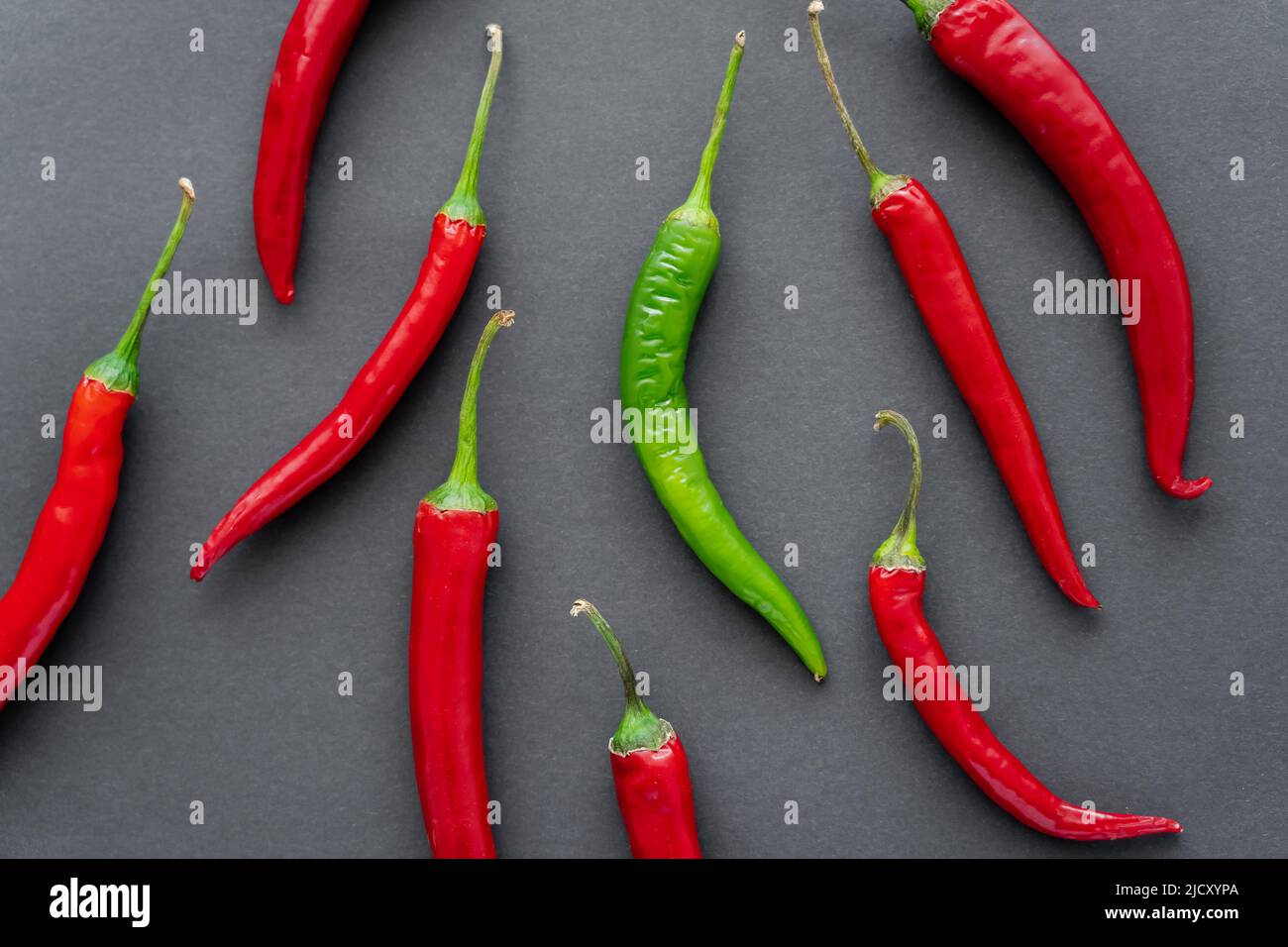 Top view of green and red chili peppers on black background Stock Photo ...