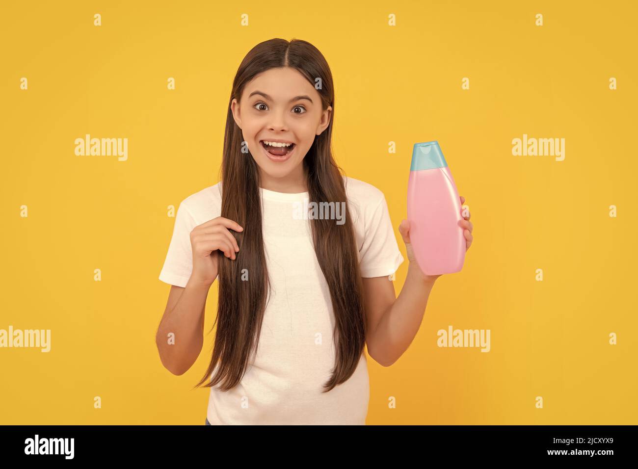 kid use shower gel. shampooing long hair in salon. child with