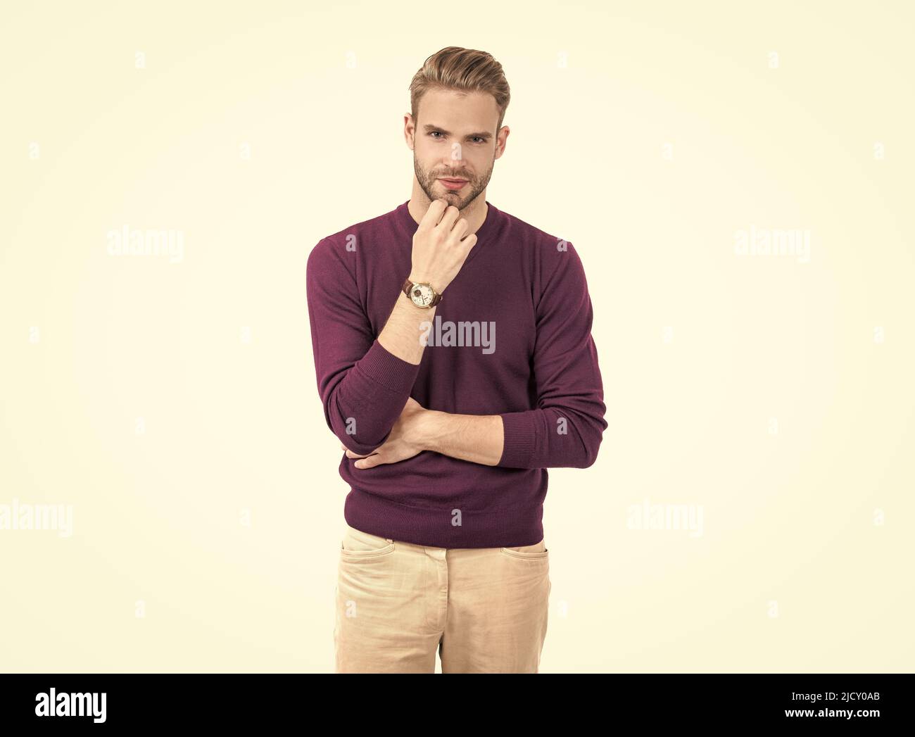 Handsome man with unshaven face skin wear violet pullover with casual pants, on-trend Stock Photo