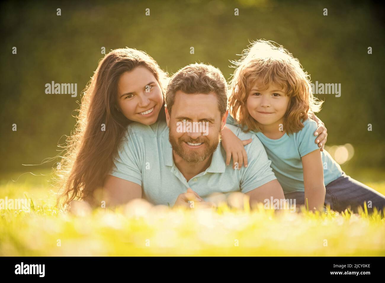 family day. friendship. father mother and child on green park grass ...