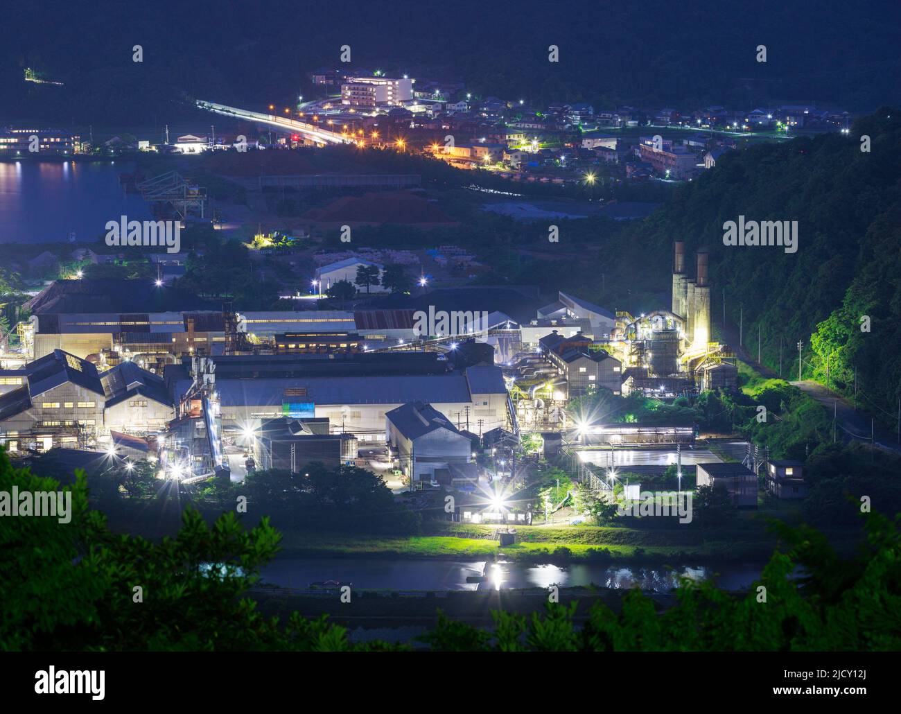 Lights from small factory in countryside at night Stock Photo