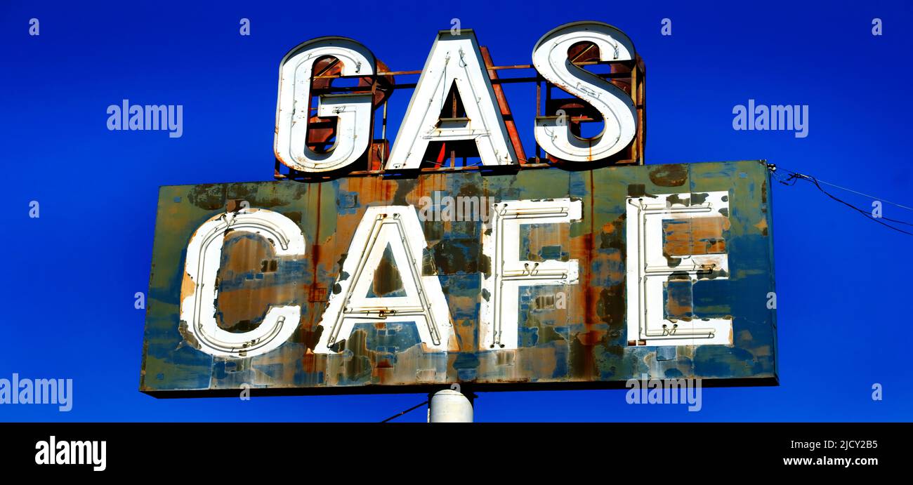 Old vintage gas cafe sign blue sky worn Americana on road roadside