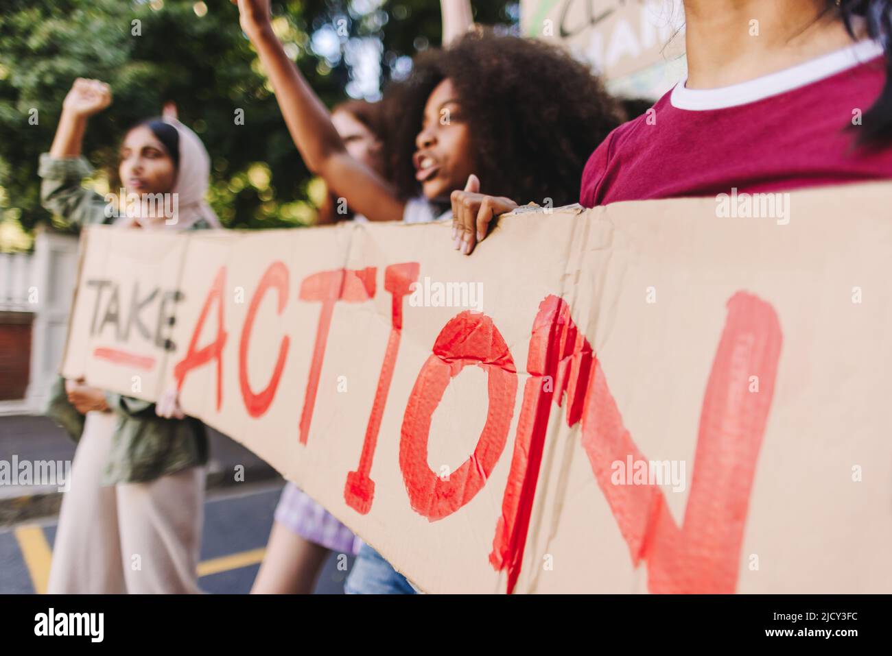 Teenagers taking action against climate change. Group of youth activists protesting against global warming and pollution. Multicultural young people j Stock Photo