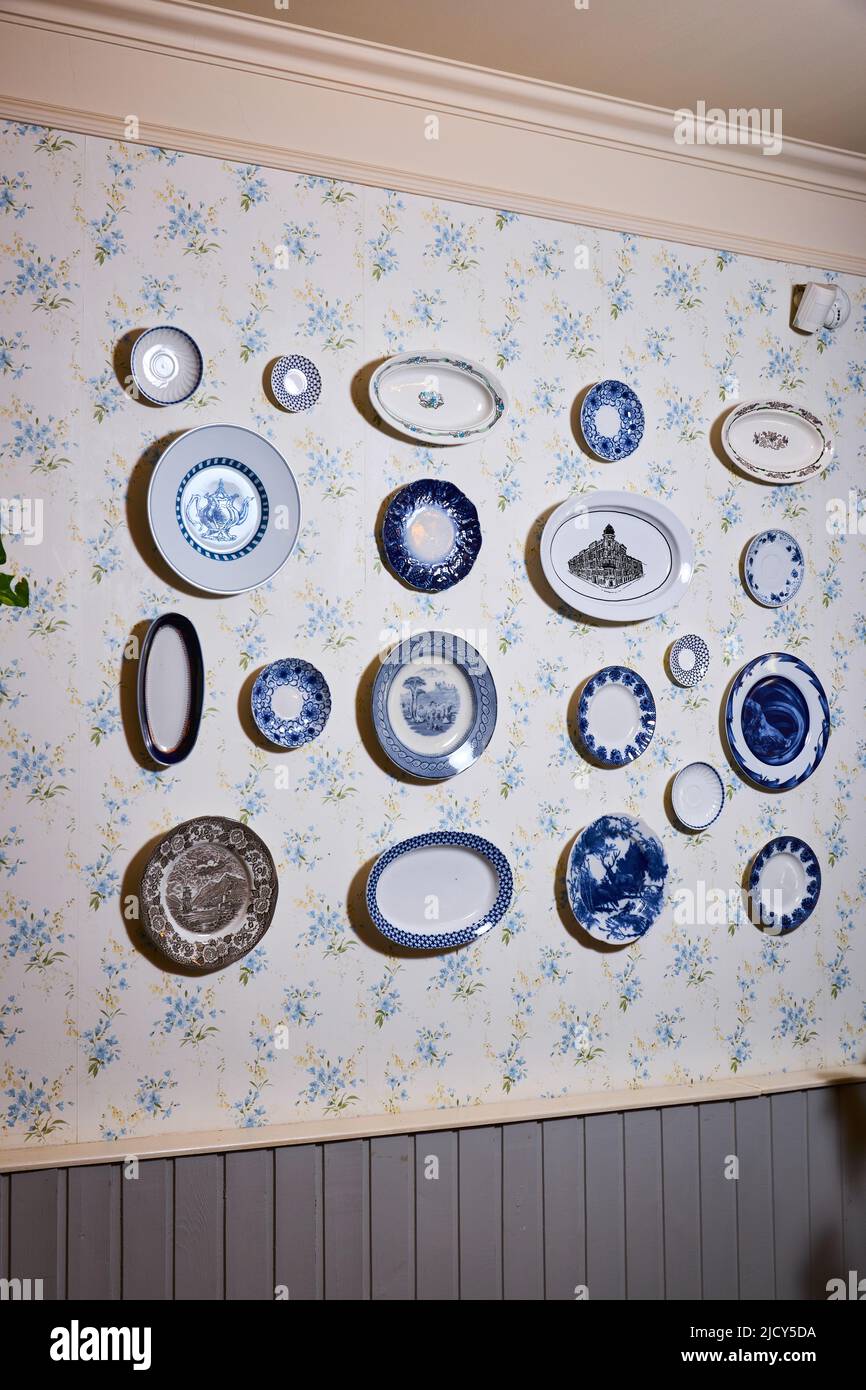 Beautiful porcelain plates hang on the wall  Stock Photo
