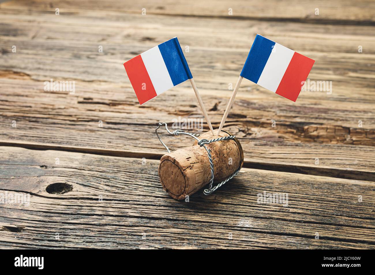 French flags on a french champagne bottle cork on an old wooden table, Bastille Day and French National Day 14 July concept Stock Photo
