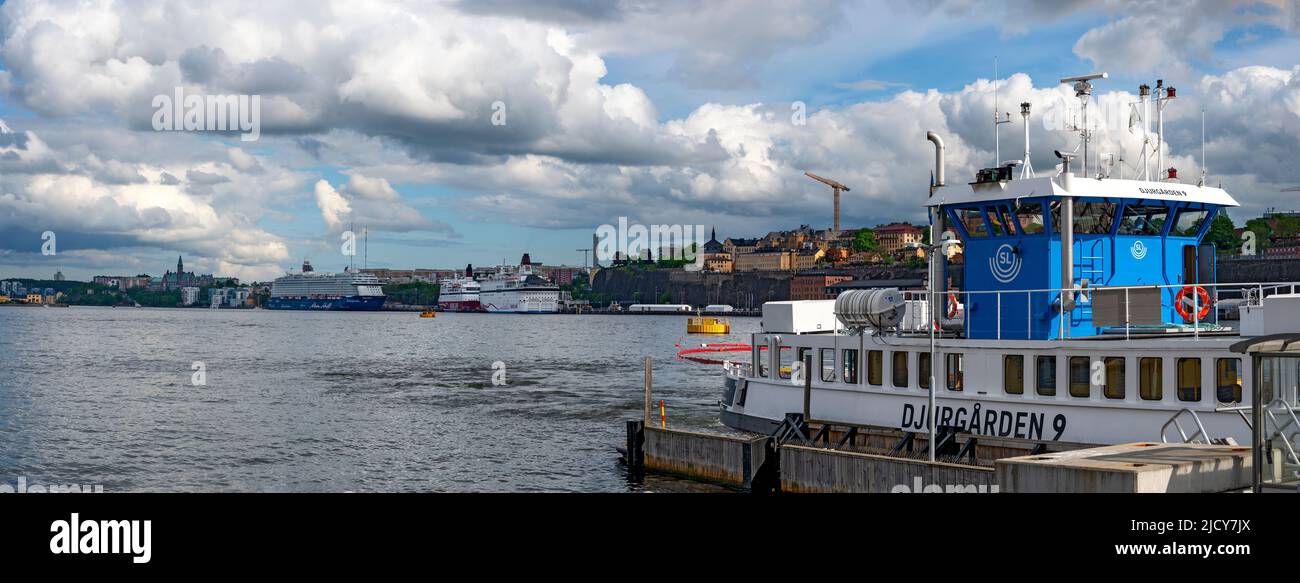 panoramic view from Slussen in direction of the district Södermalm with a ferry to Djugarden on the right and cruiseships in the background, Stockholm Stock Photo