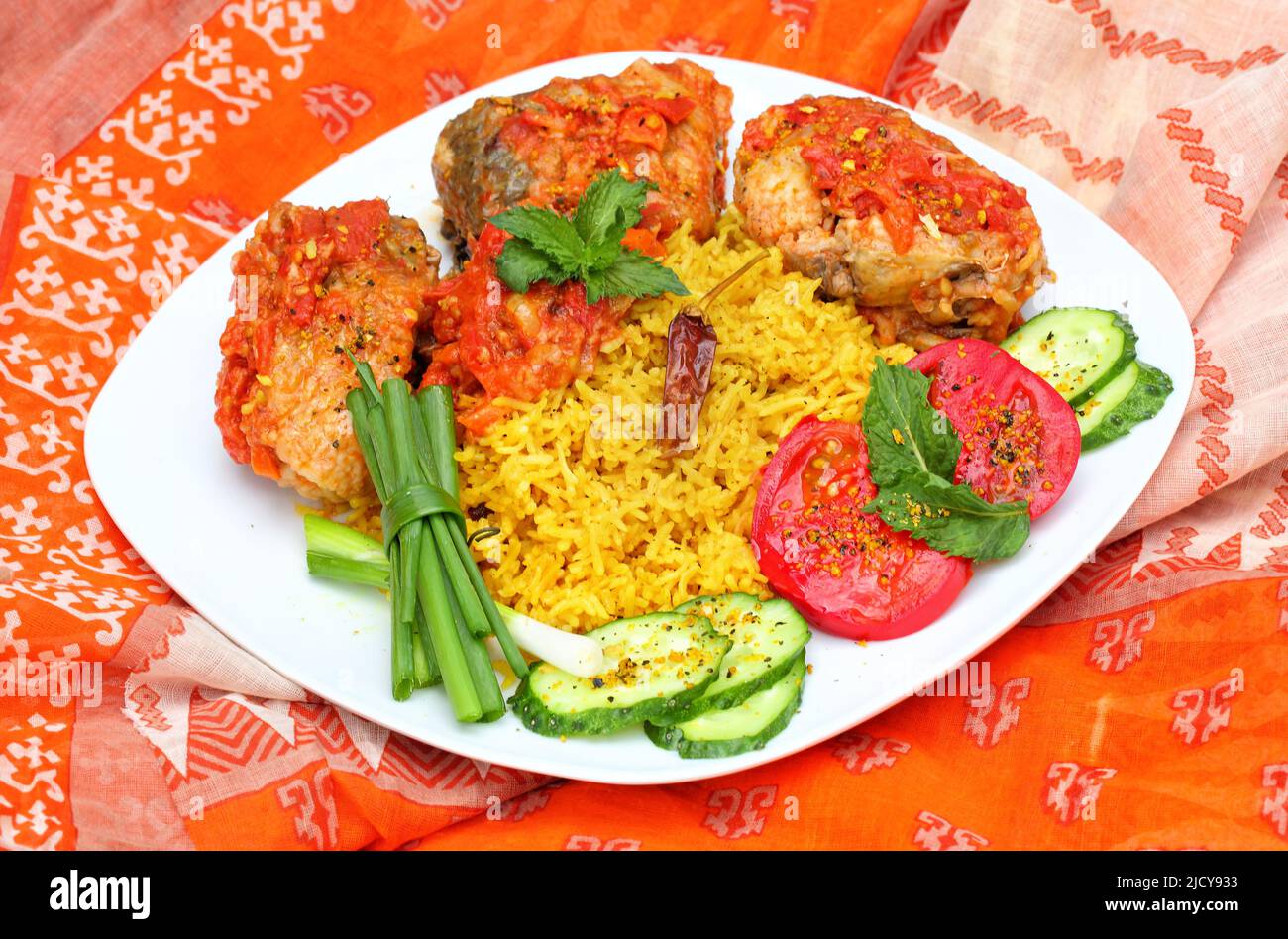 Fried fish in tomato sauce with basmati rice. Indian food Stock Photo