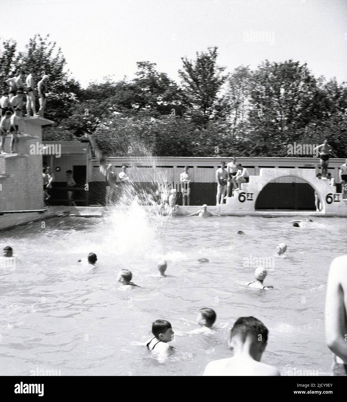 1940s, historical, children playing at the outdoor swiming pool, the
