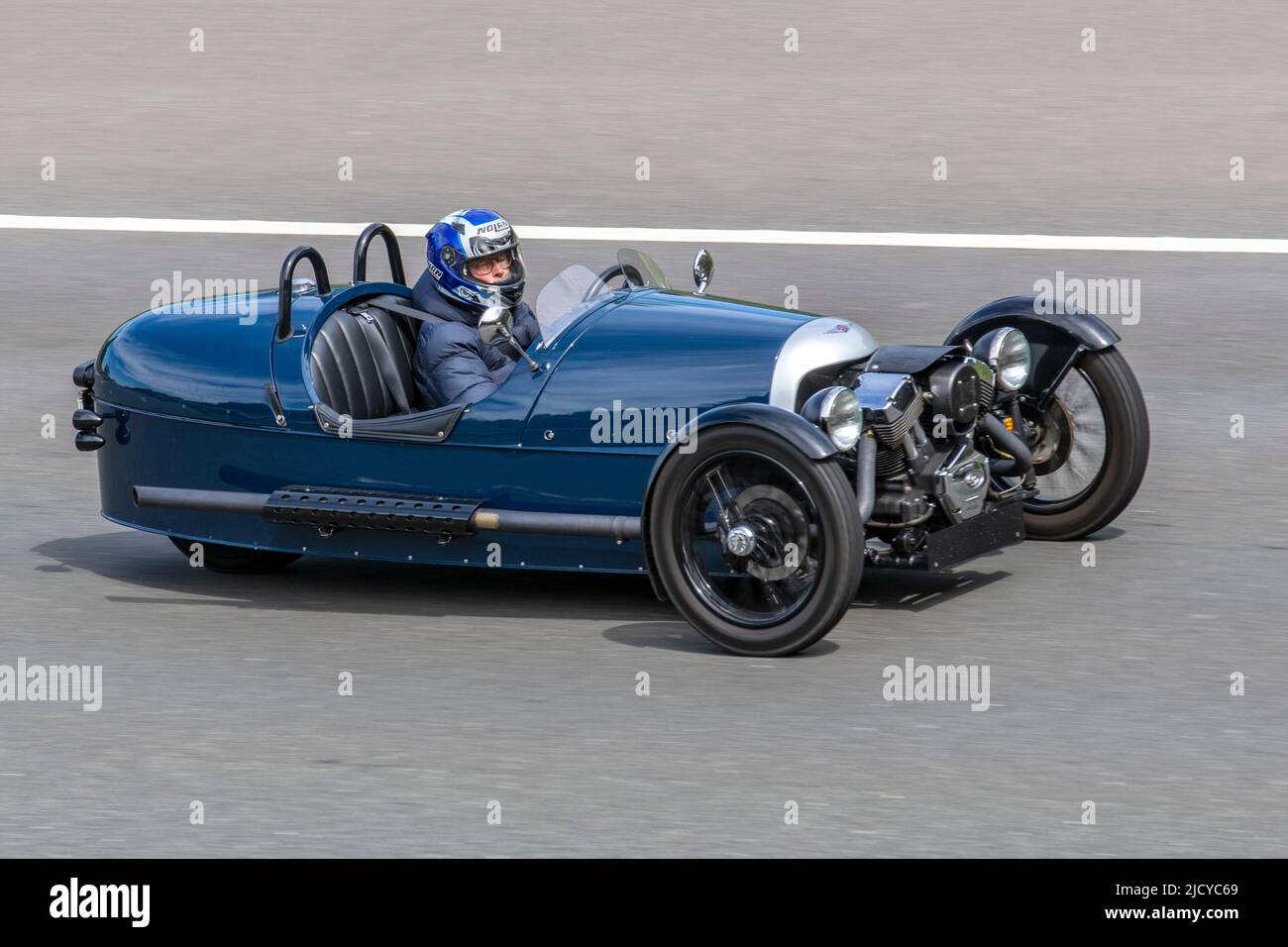 Morgan 3 Wheeler P101, Just 33 made, the Aero-disc wheels, with low-slung Hella spotlights to reduce turbulence around the suspension components. No roof, no doors, and no windscreen driving on the M6 motorway UK Stock Photo