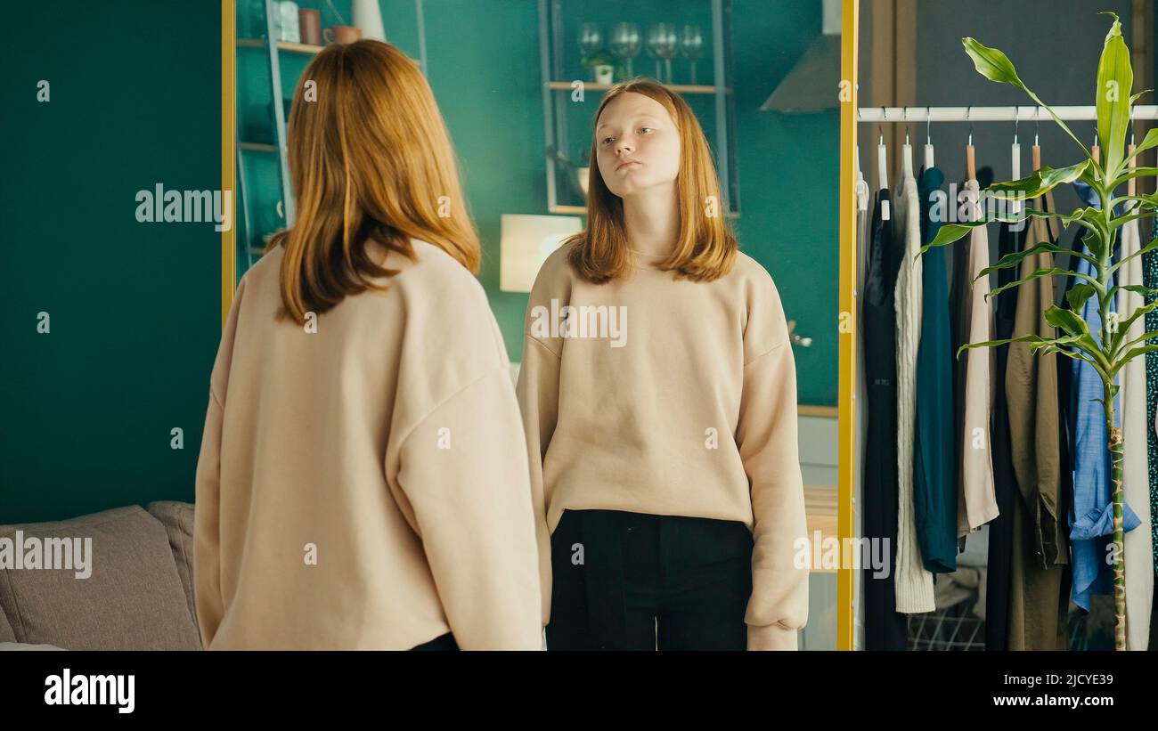 Depressed Red haired Teenage Girl Looking at Her Reflection in the ...