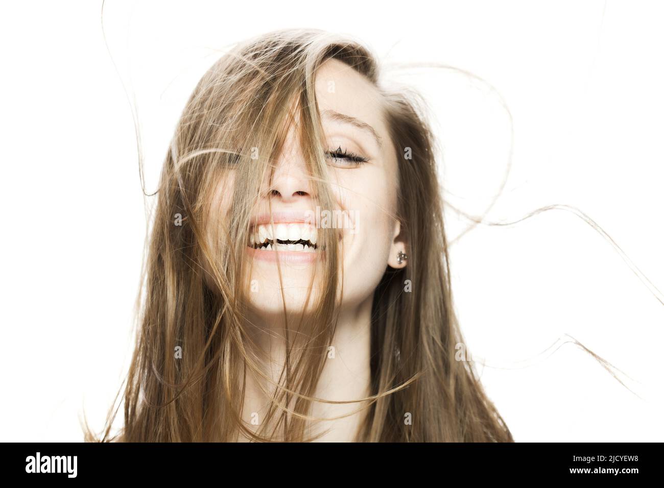 girl with flowing hair in the air studio portrait against