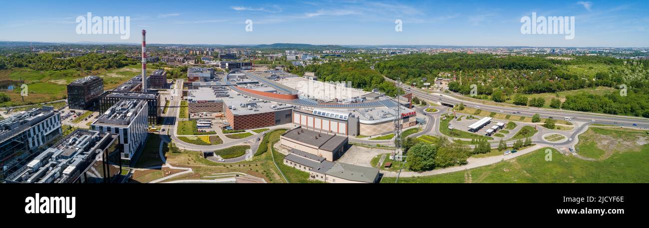 Krakow, Poland - May 19, 2022: Bonarka City Center. A complex of trade, supermarkets and office blocks with the high chimney of old factory in this pl Stock Photo