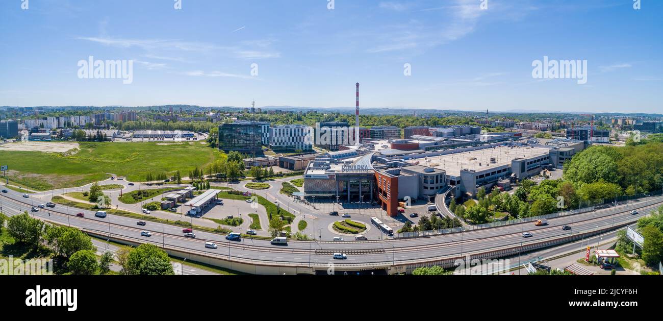 Krakow, Poland - May 19, 2022: Bonarka City Center. A complex of trade, supermarkets and office blocks with the high chimney of old factory in this pl Stock Photo