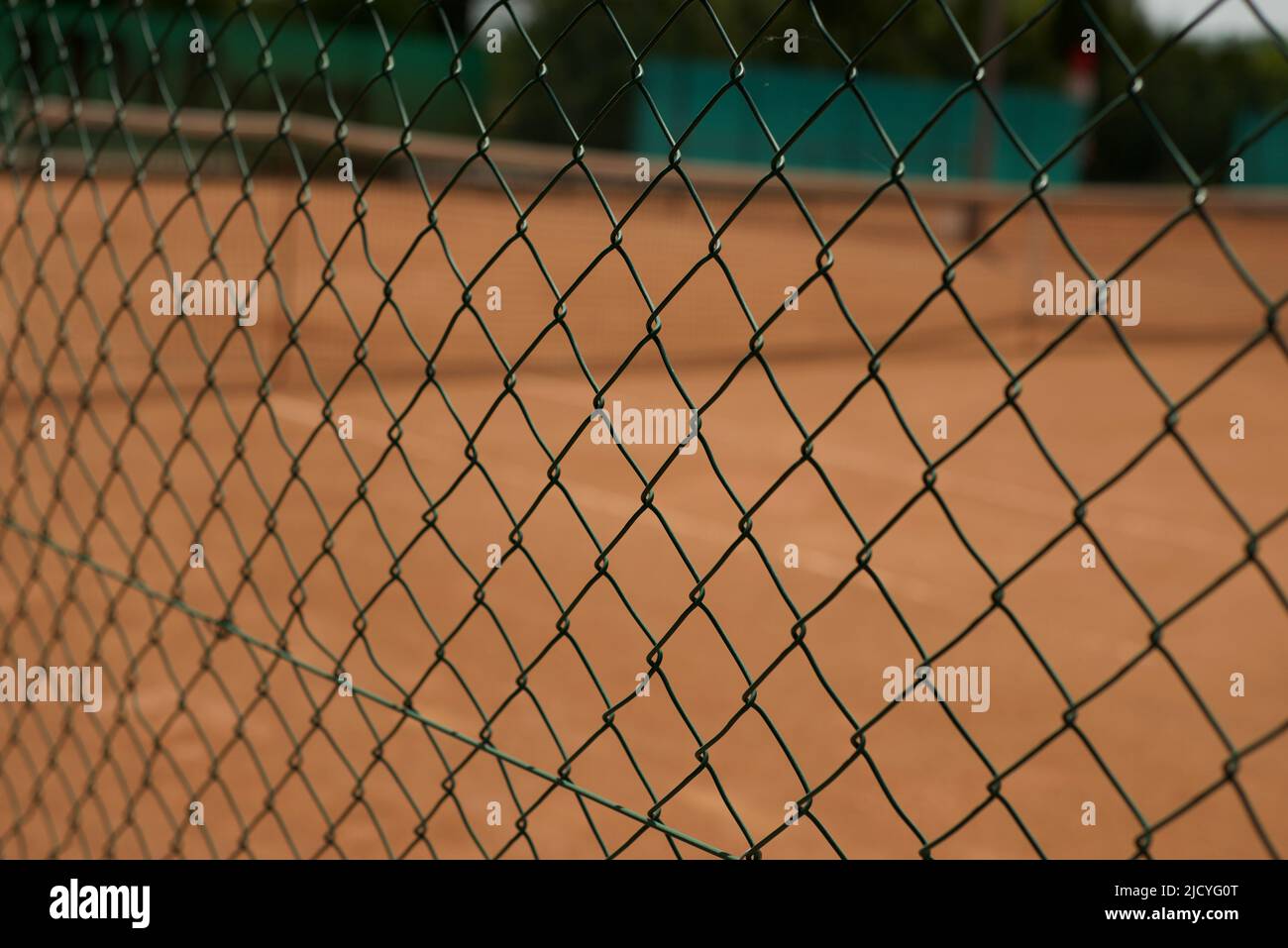 Green wire mesh fence. Mesh backgrounds. Tennis courts are fenced with